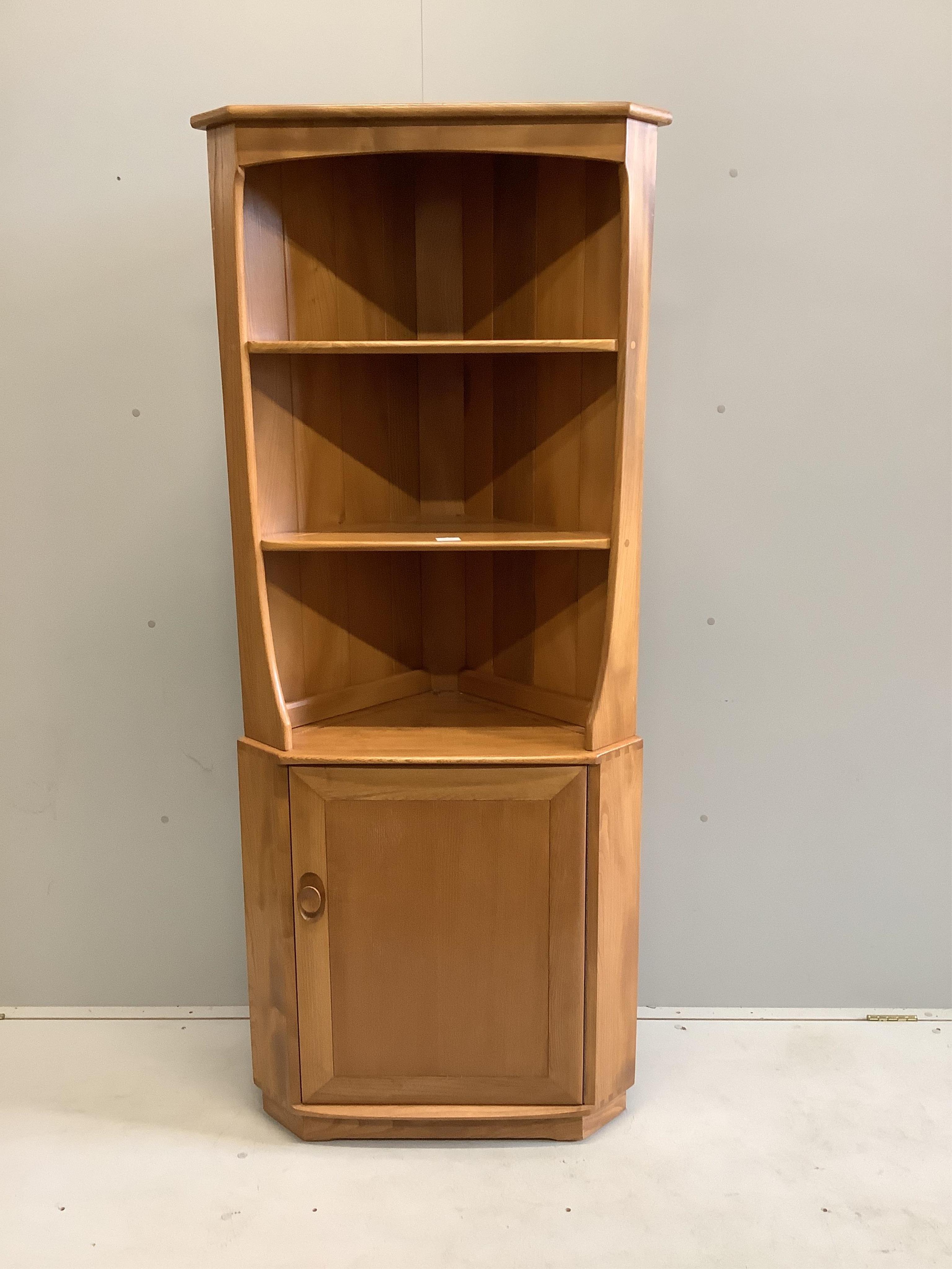 An Ercol elm standing corner cabinet, width 72cm, depth 41cm, height 179cm